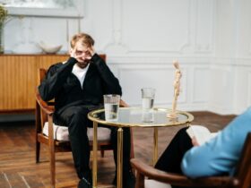 Man in Black Suit Sitting on Chair